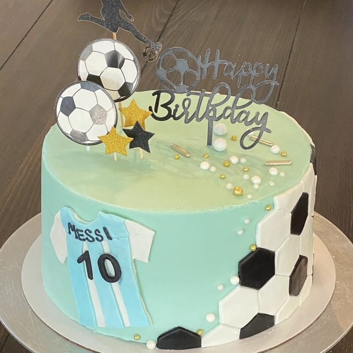 Soccer-themed birthday cake with a number 10 jersey and soccer ball panels